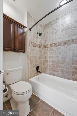 a bathroom with a toilet and bathtub