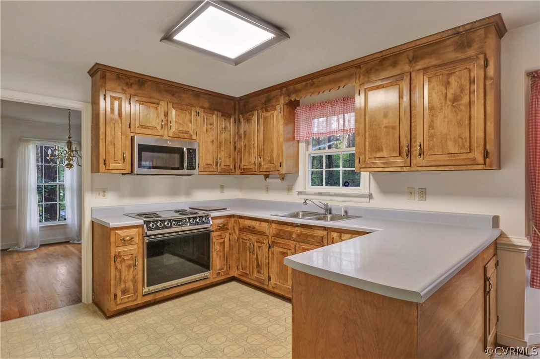 6201 Lansgate Road Midlothian, VA 23112 - Photo 9 of 31 a kitchen that has a sink a stove and lots of wooden cabinets