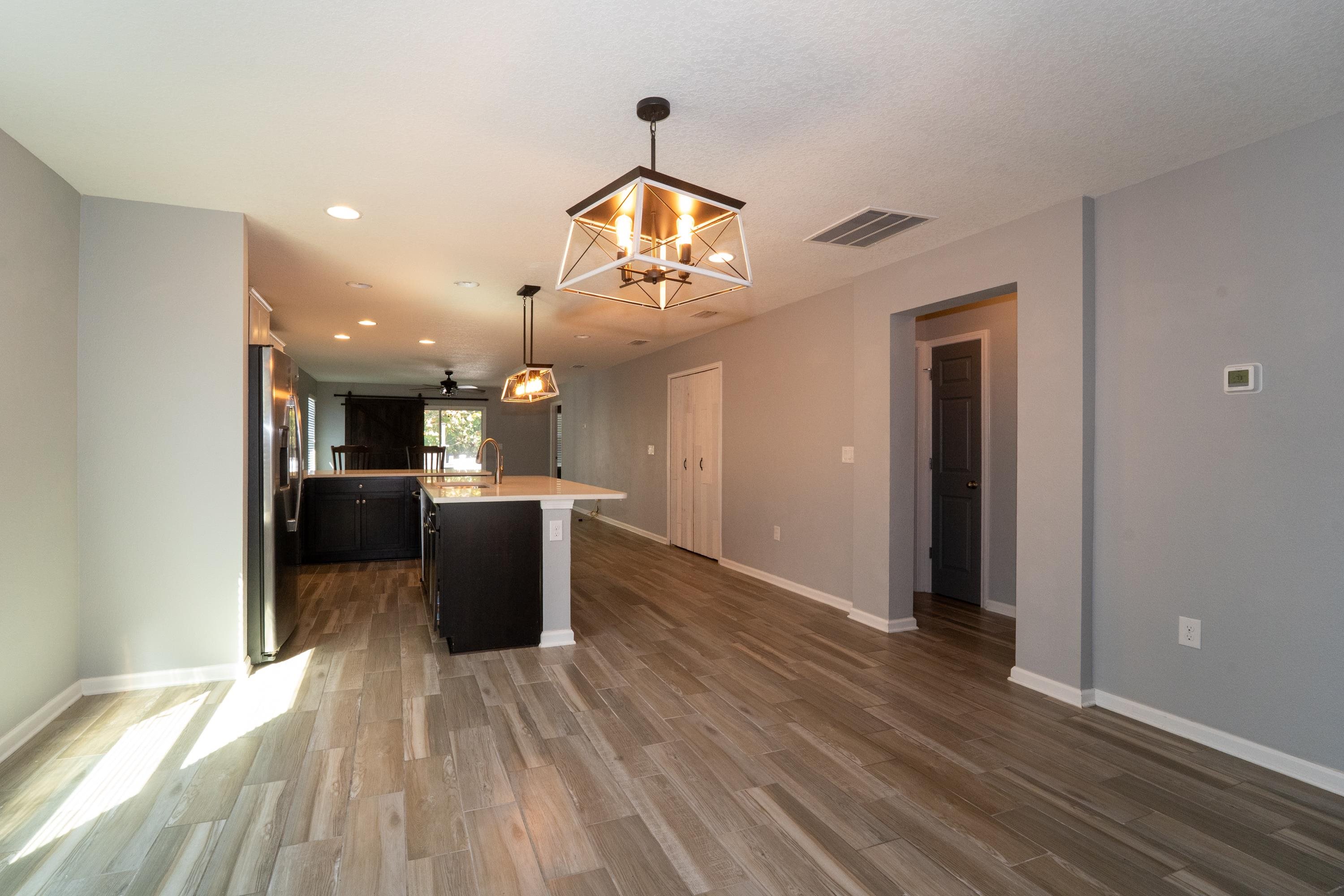 415 Santorini Court St. Augustine, FL 32086 - Photo 11 of 52 Kitchen featuring a chandelier, a center island with sink, pendant lighting, recessed lighting, and stainless steel fridge with ice dispenser