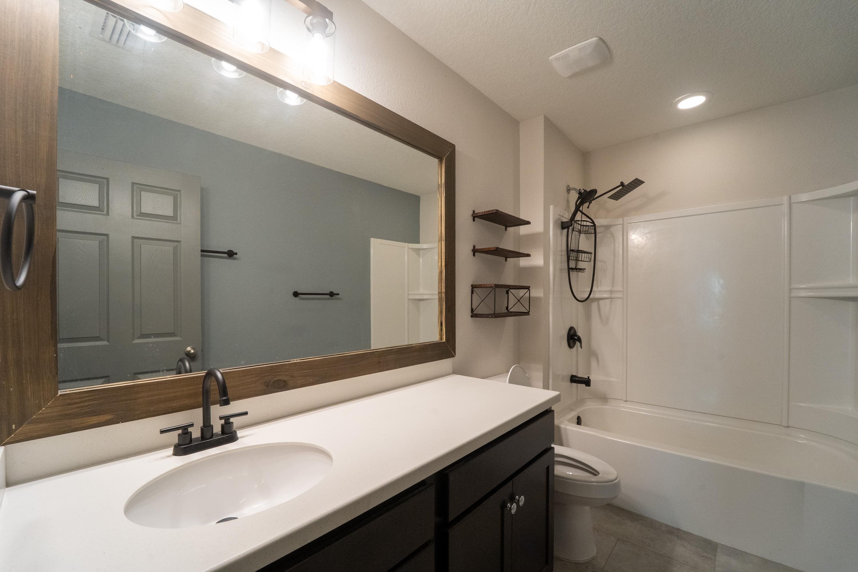 415 Santorini Court St. Augustine, FL 32086 - Photo 20 of 52 a bathroom with a sink double vanity granite tub shower and a mirror