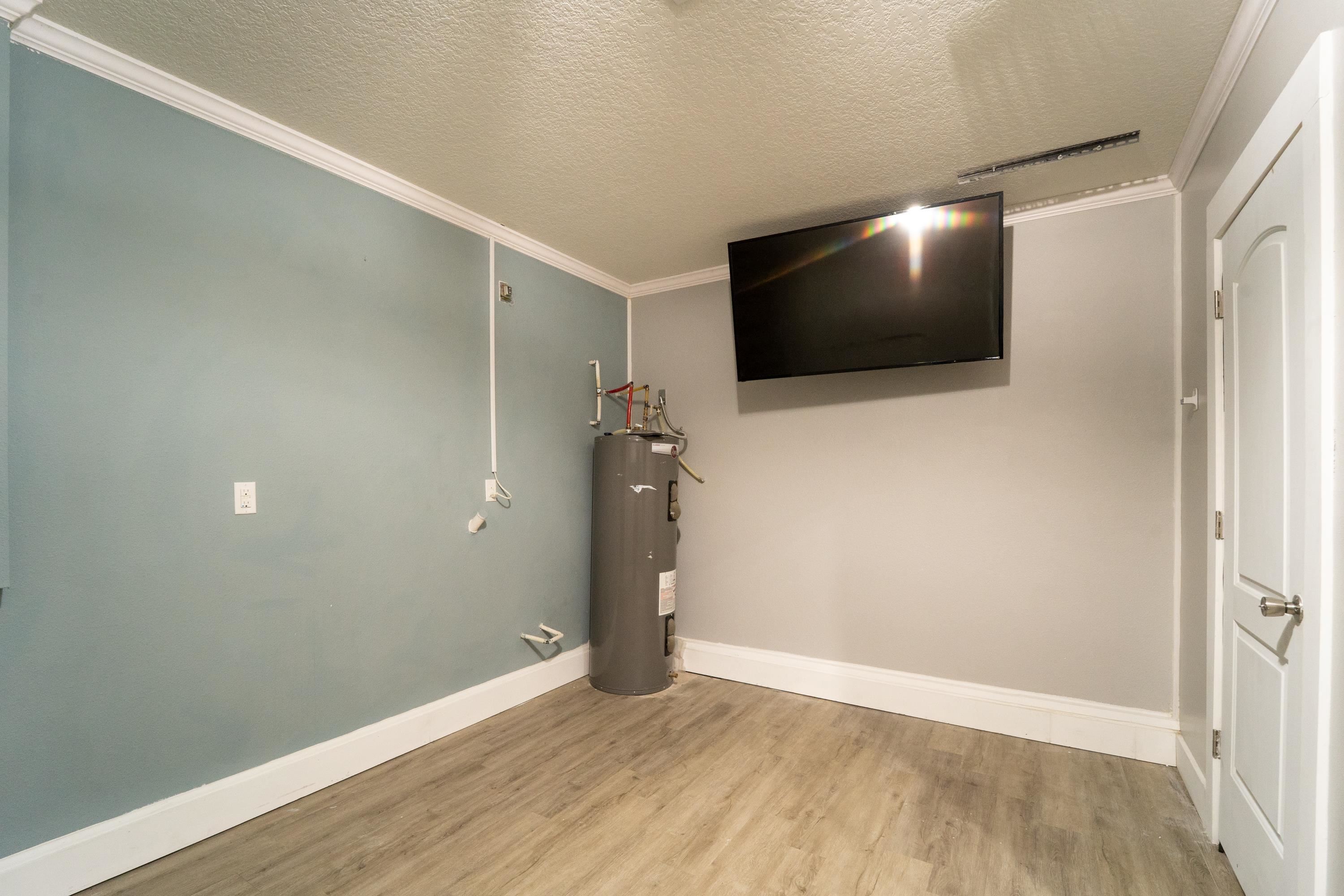 415 Santorini Court St. Augustine, FL 32086 - Photo 27 of 52 a view of a livingroom with wooden floor and flat screen tv