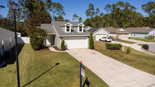 an aerial view of a house with a yard