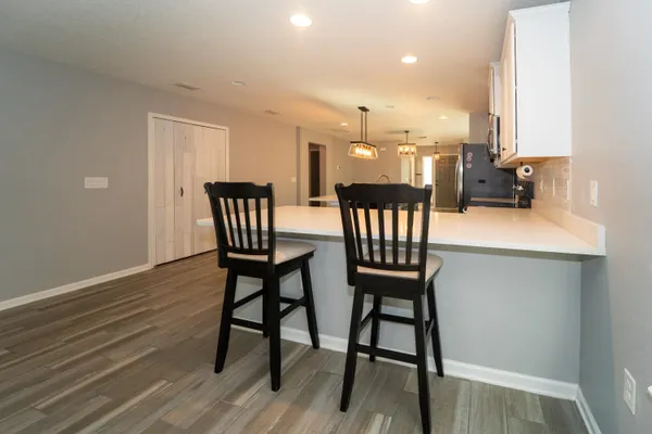 a dining room with furniture and wooden floor