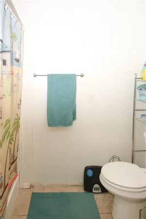 a bathroom with a sink toilet and mirror