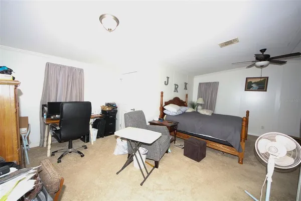 a work room with furniture and a fan