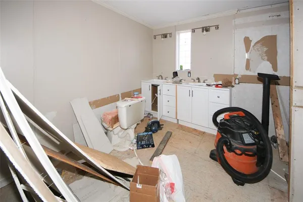 a view of walk in closet with clothes