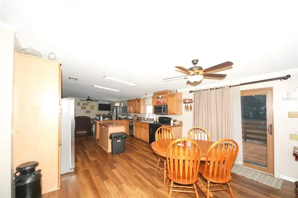 a kitchen with granite countertop a stove top oven a sink dishwasher and a microwave oven with cabinets