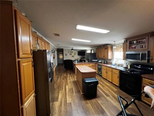 a kitchen with stainless steel appliances granite countertop a refrigerator stove and sink