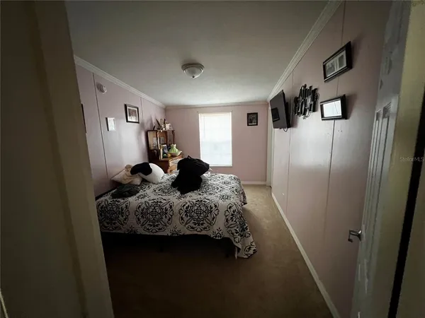 a bedroom with a bed and a mirror