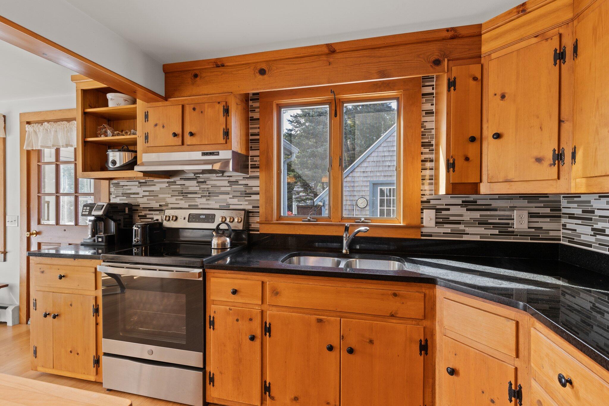 176 Maple Street West Barnstable, MA 02668 - Photo 17 of 83 a kitchen with stainless steel appliances granite countertop a stove a sink and a microwave