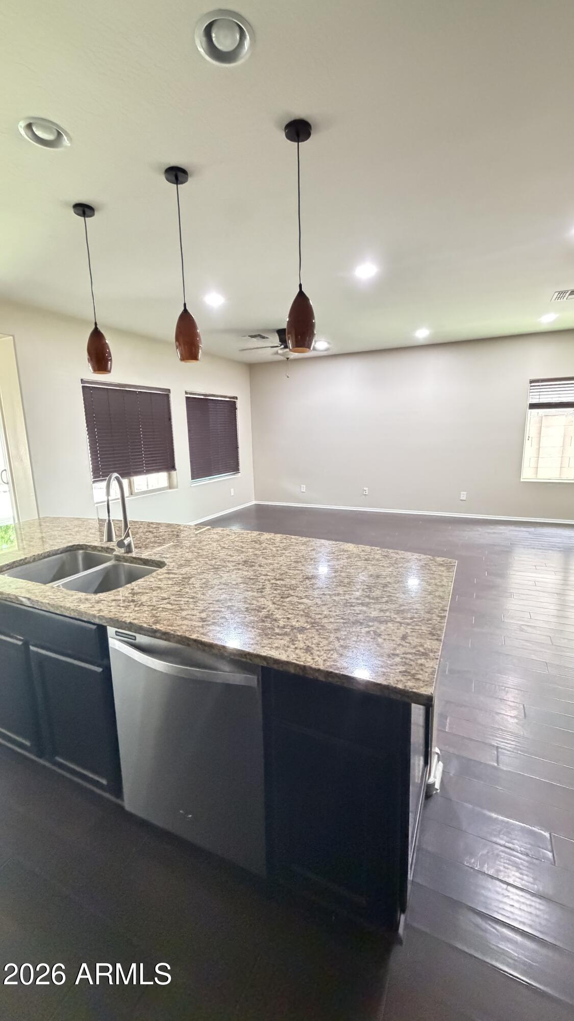 10786 West Yearling Road Peoria, AZ 85383 - Photo 6 of 21 a kitchen with stainless steel appliances granite countertop a sink a stove and a wooden floor