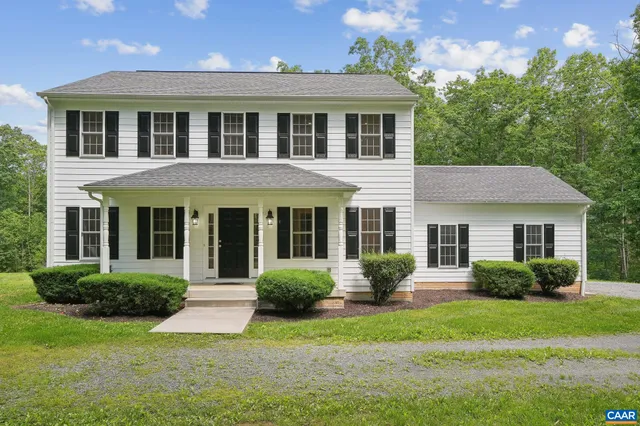 a front view of a house with garden and porch
