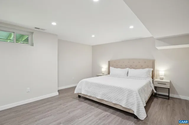 a kitchen with stainless steel appliances granite countertop a refrigerator a stove a sink a dining table and chairs