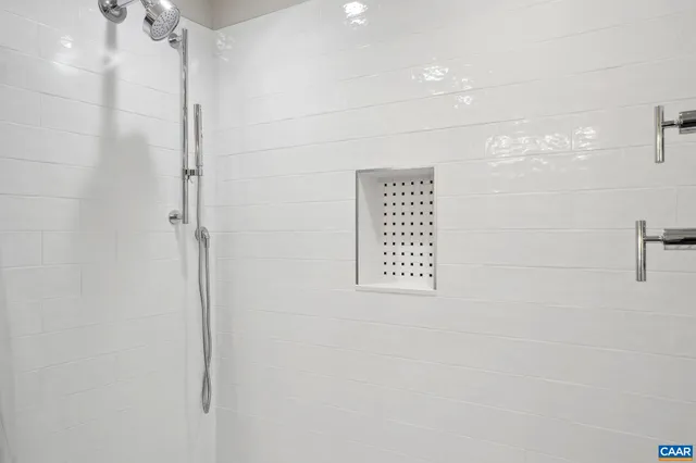 a large kitchen with granite countertop a large counter top stainless steel appliances a sink cabinets and a window