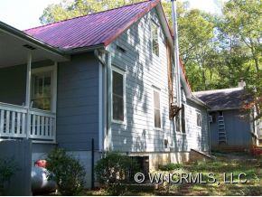 130 Bradshaw Road Tryon, NC 28782 - Photo 3 of 16 a front view of a house with garden