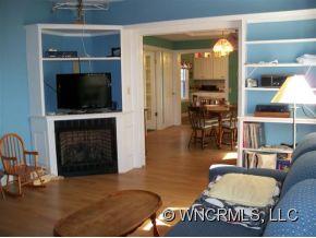 130 Bradshaw Road Tryon, NC 28782 - Photo 5 of 16 a living room with furniture a flat screen tv and a fireplace