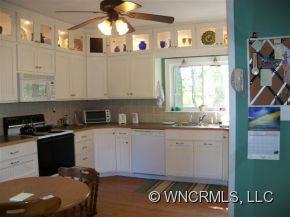 130 Bradshaw Road Tryon, NC 28782 - Photo 8 of 16 a kitchen with stainless steel appliances granite countertop a stove a sink and a microwave