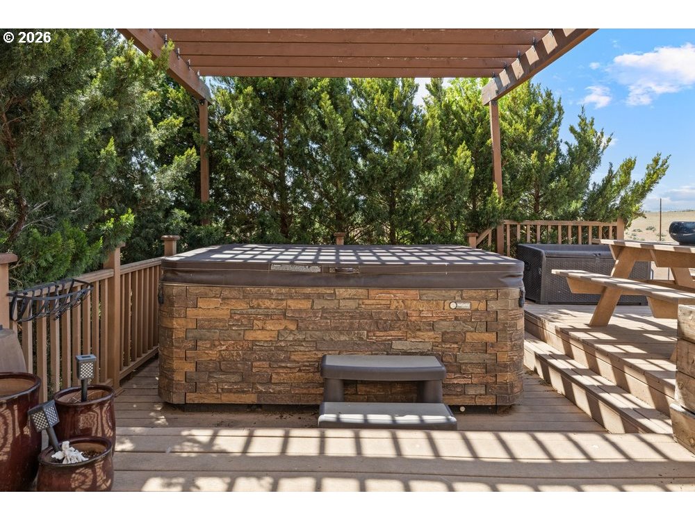 500 St Hilaire Road Yakima, WA 98901 - Photo 24 of 29 a view of a patio with table and chairs with wooden floor and fence
