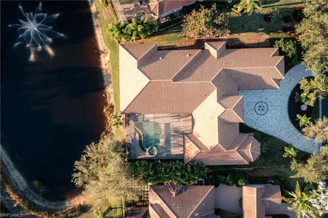 an aerial view of a house with garden space and street view