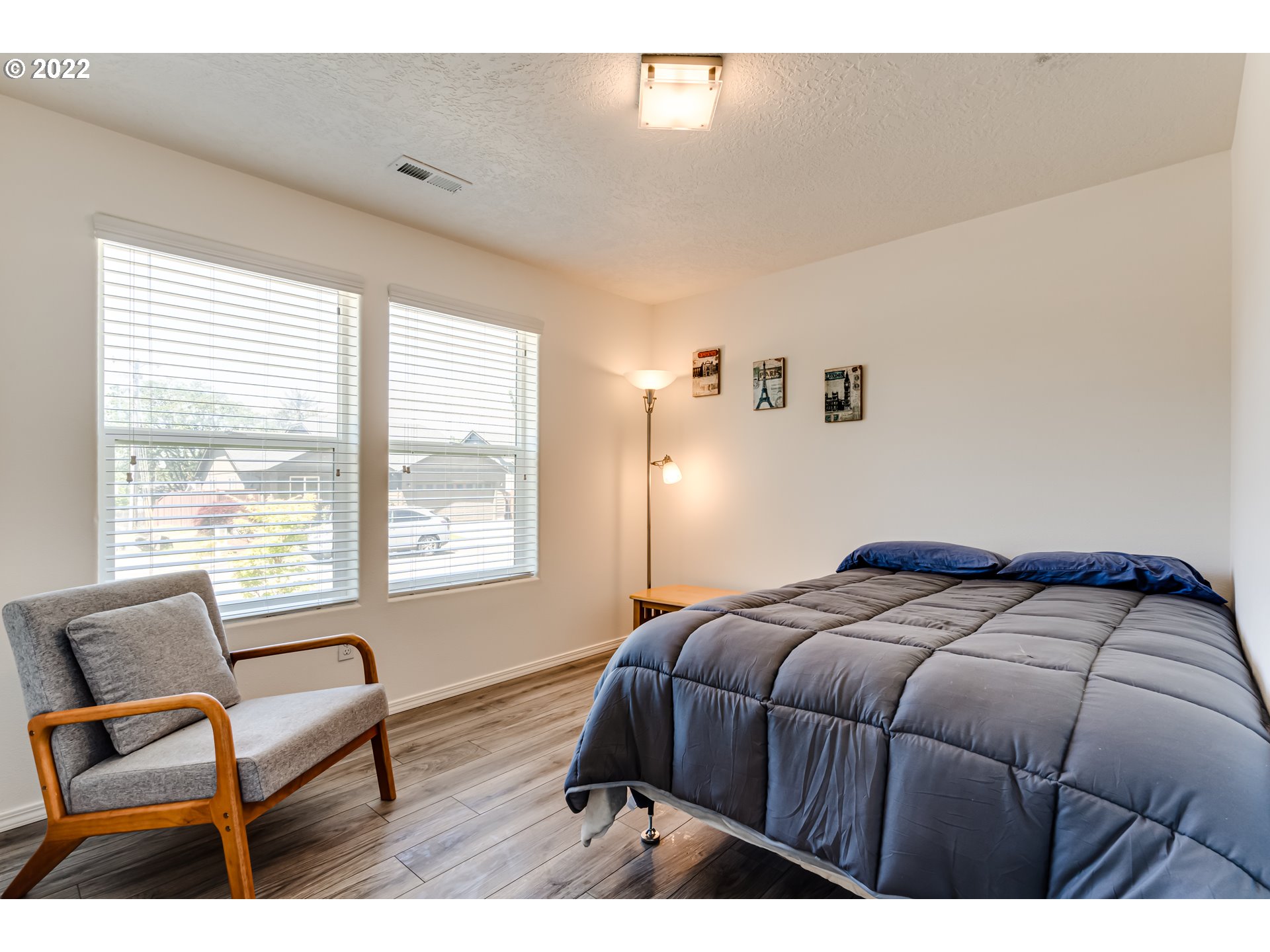 569 South 48th Street Springfield, OR 97478 - Photo 13 of 23 a bedroom with a bed a couch and a window