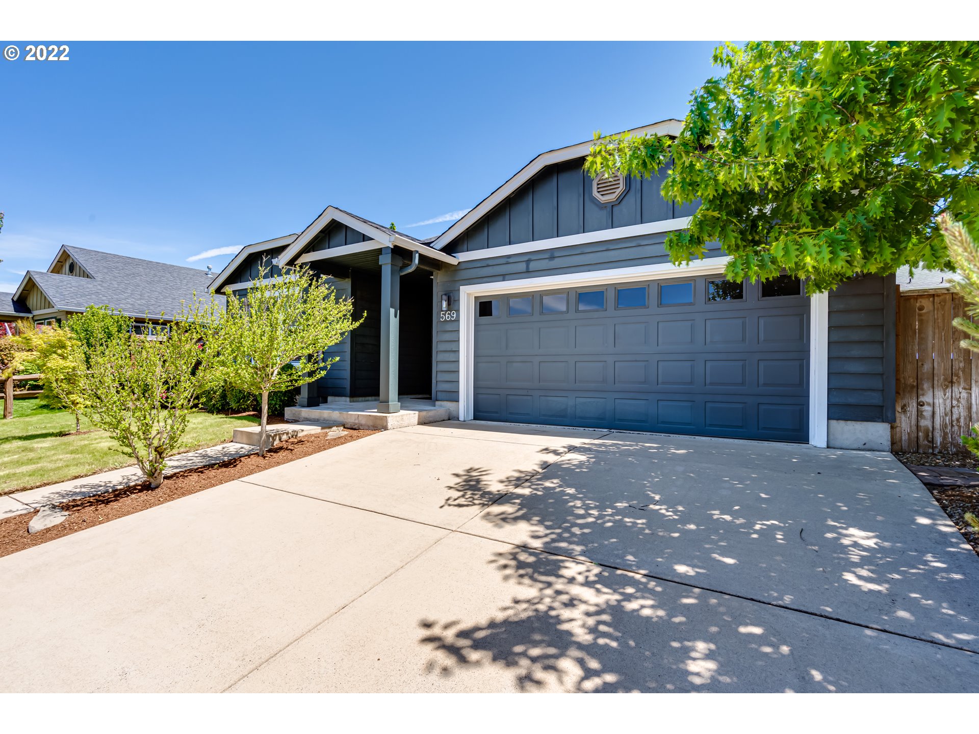 569 South 48th Street Springfield, OR 97478 - Photo 4 of 23 a front view of a house with a yard and garage