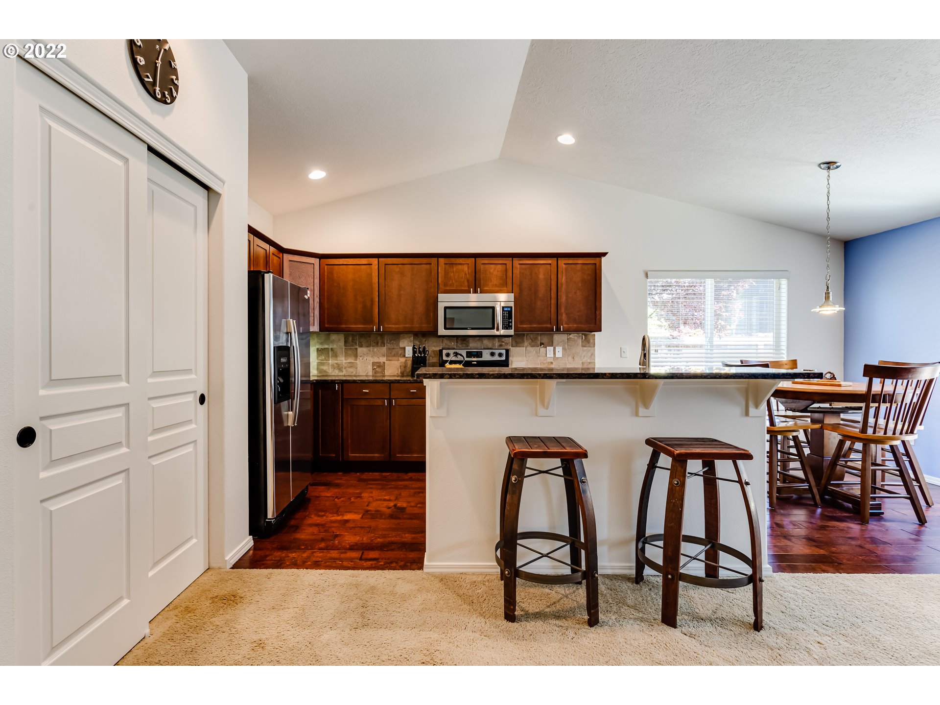 569 South 48th Street Springfield, OR 97478 - Photo 7 of 23 a kitchen with stainless steel appliances kitchen island granite countertop a refrigerator and microwave