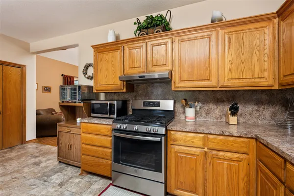 a kitchen with granite countertop cabinets and window