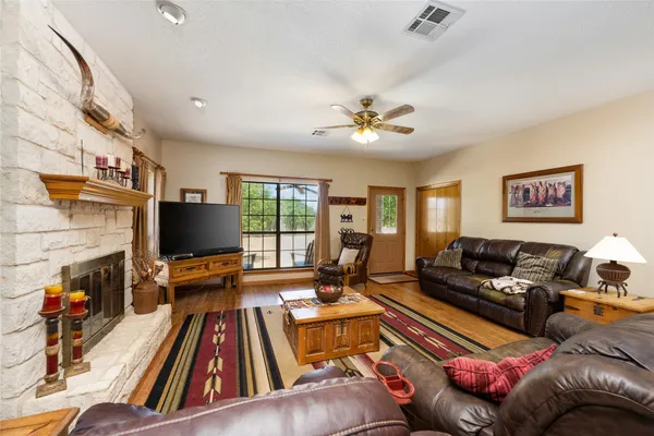 a living room with furniture a flat screen tv and a fireplace