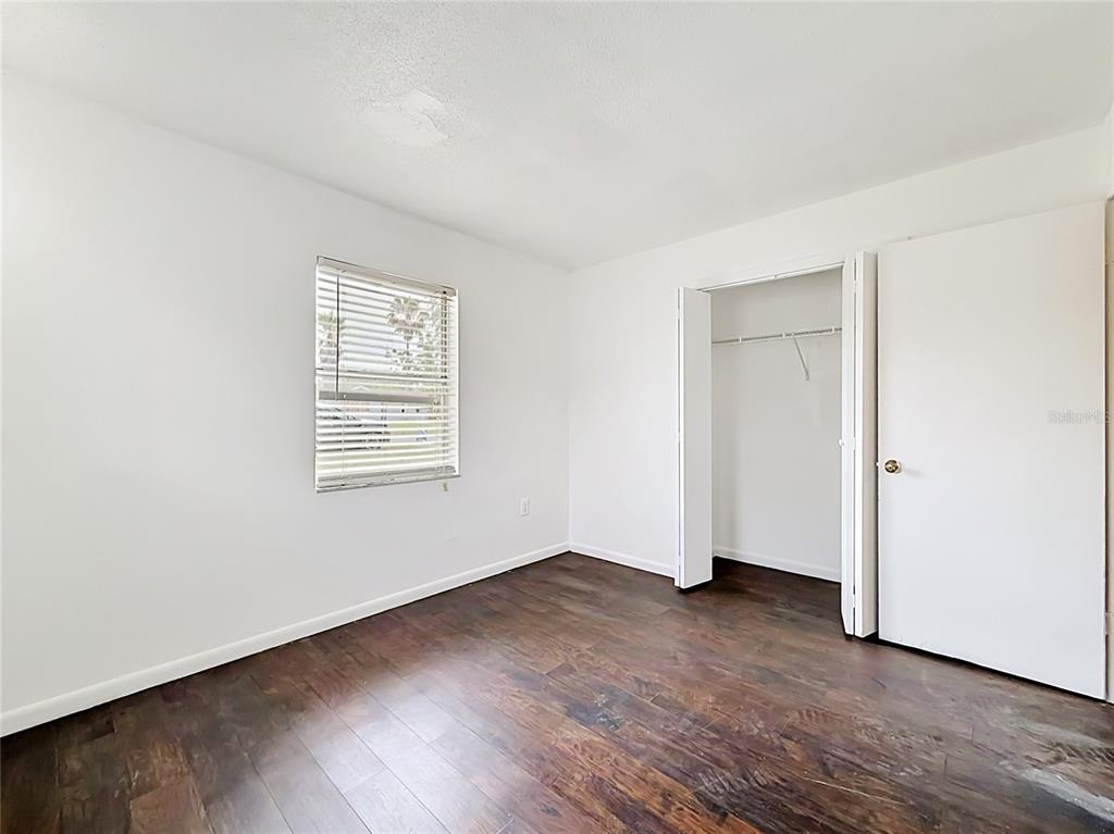 3 Bahia Pl Loop Ocala, FL 34472 - Photo 13 of 31 an empty room with wooden floor and windows