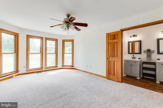 a view of a room with a kitchen and a sink