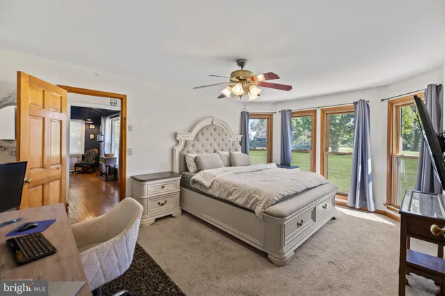 a spacious bedroom with a bed and a large window