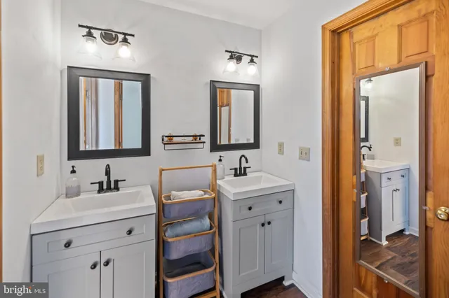 a bathroom with a double vanity sink mirror and