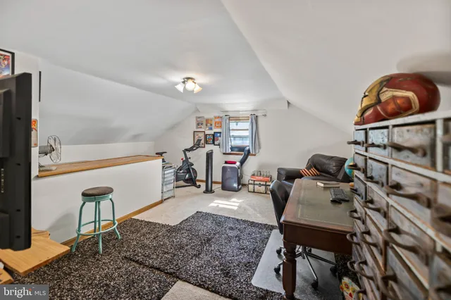 a living room with furniture a rug and a painting on the wall