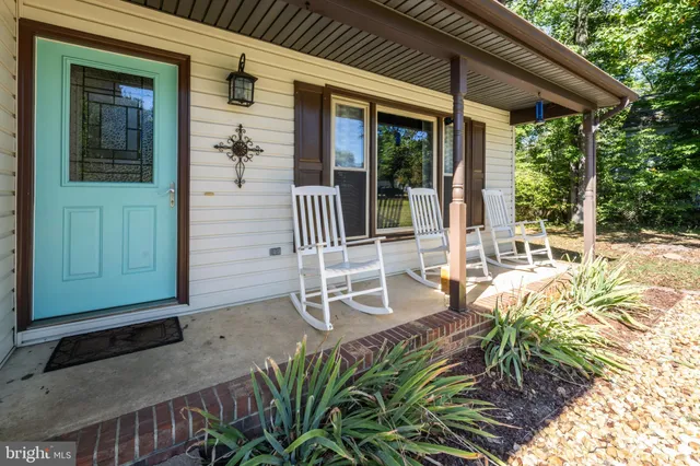 a view of a patio with table and chairs and potted plants