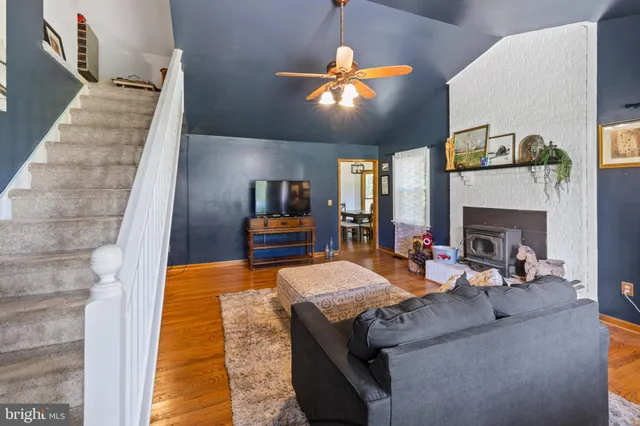 a living room with fireplace furniture and a flat screen tv