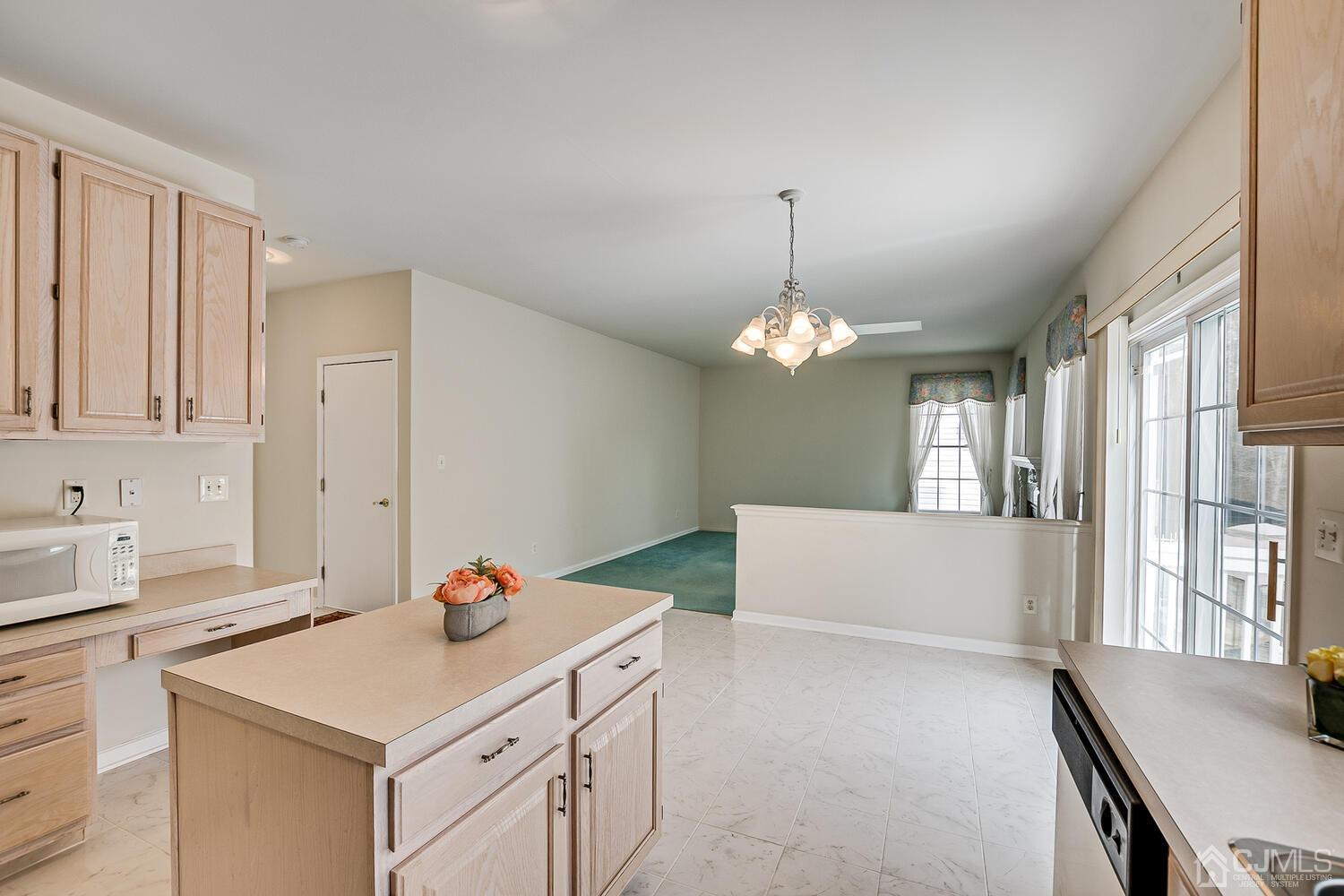 22 Timber Ridge Road North Brunswick, NJ 08902 - Photo 13 of 50 a view of kitchen island with furniture and chandelier
