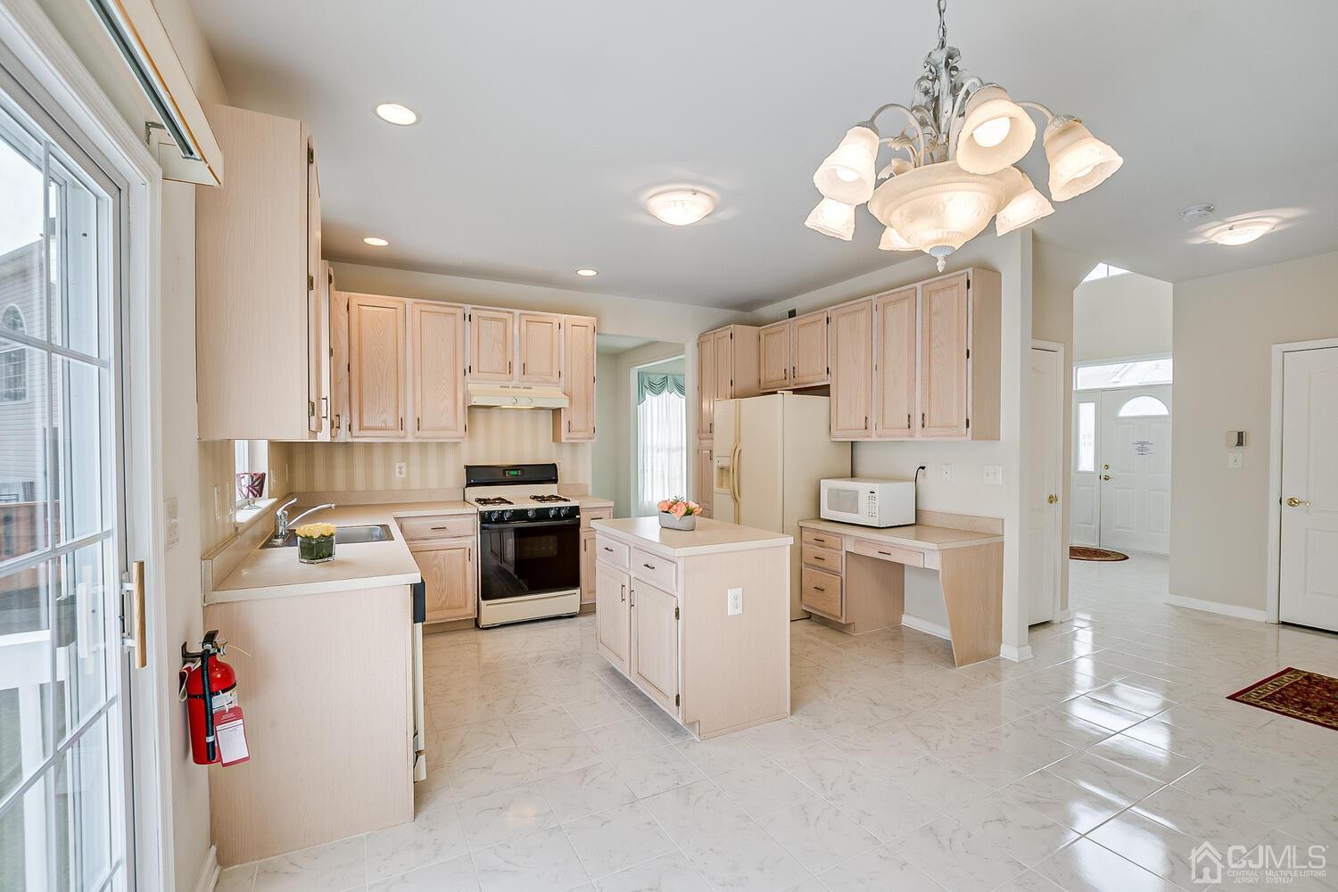 22 Timber Ridge Road North Brunswick, NJ 08902 - Photo 14 of 50 a kitchen that has a lot of white cabinets and stainless steel appliances
