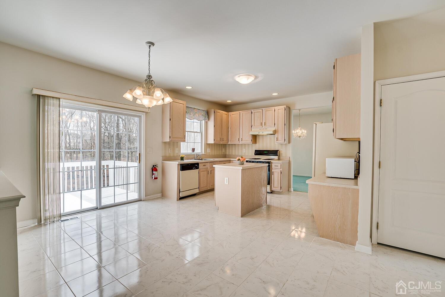 22 Timber Ridge Road North Brunswick, NJ 08902 - Photo 18 of 50 a kitchen with white cabinets and refrigerator