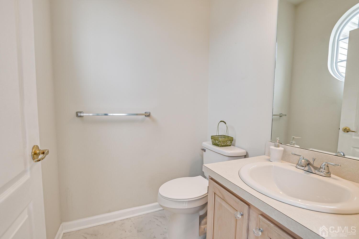 22 Timber Ridge Road North Brunswick, NJ 08902 - Photo 24 of 50 a bathroom with a sink a toilet and a mirror