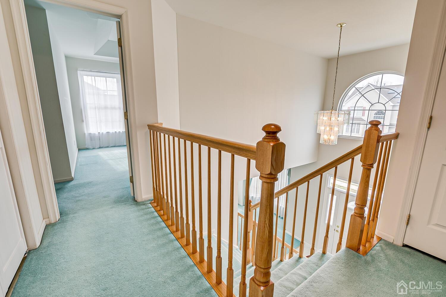 22 Timber Ridge Road North Brunswick, NJ 08902 - Photo 27 of 50 a view of a hallway with wooden floor and stairs