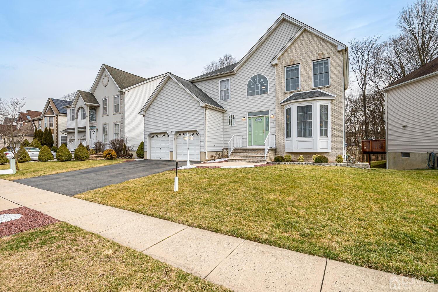 22 Timber Ridge Road North Brunswick, NJ 08902 - Photo 3 of 50 a front view of a house with a yard
