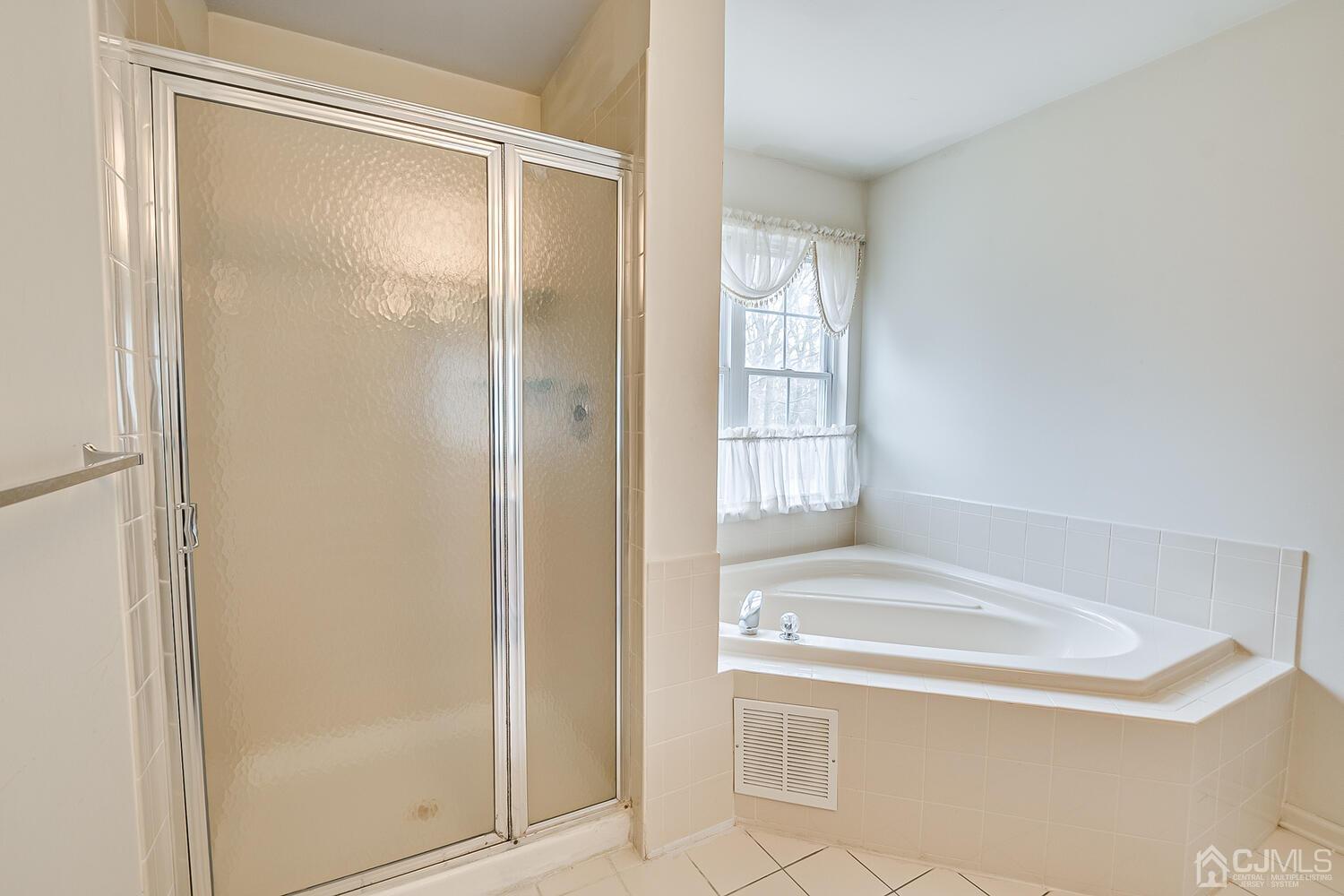22 Timber Ridge Road North Brunswick, NJ 08902 - Photo 33 of 50 a bathroom with a tub and shower