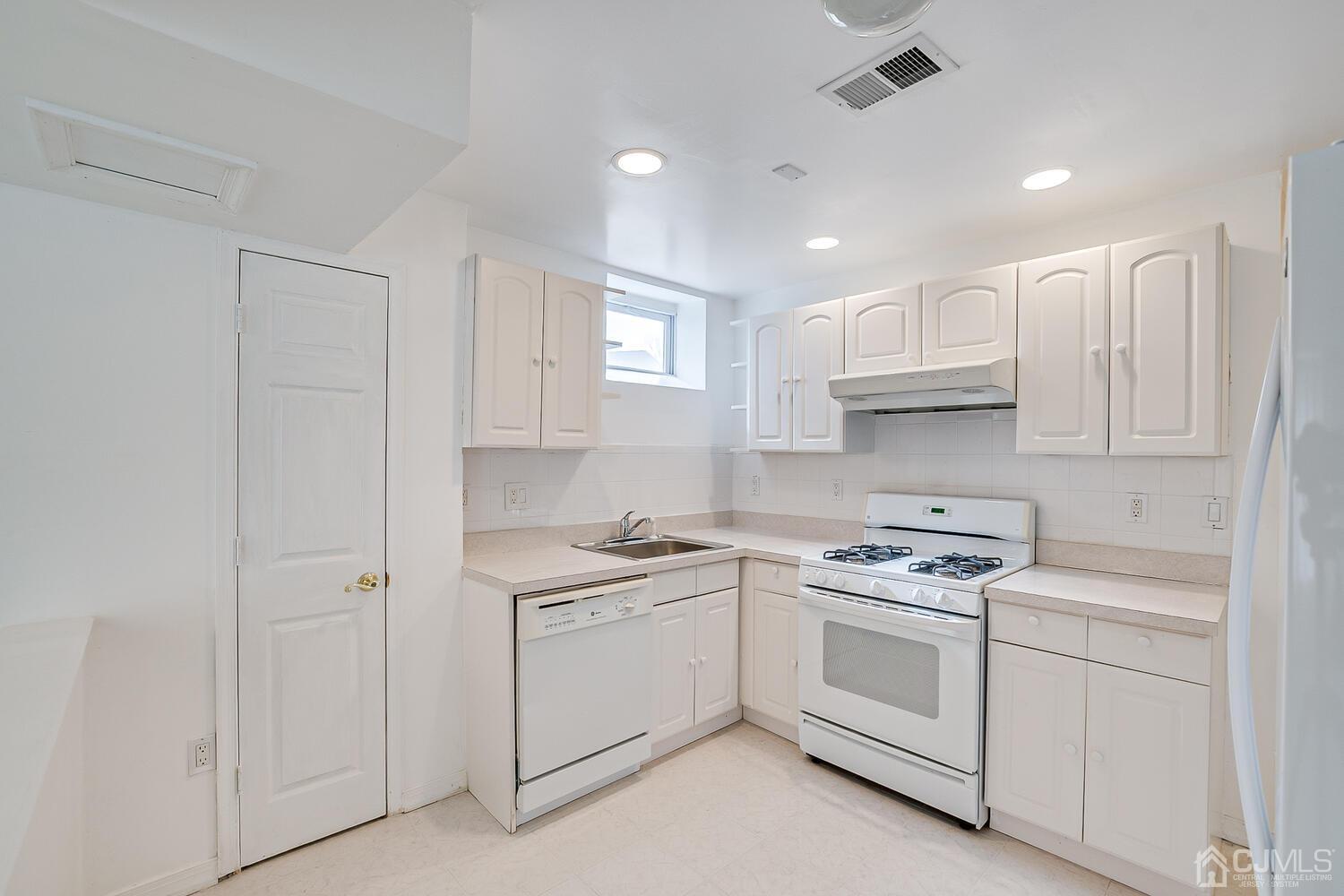 22 Timber Ridge Road North Brunswick, NJ 08902 - Photo 39 of 50 a kitchen with white cabinets and white appliances