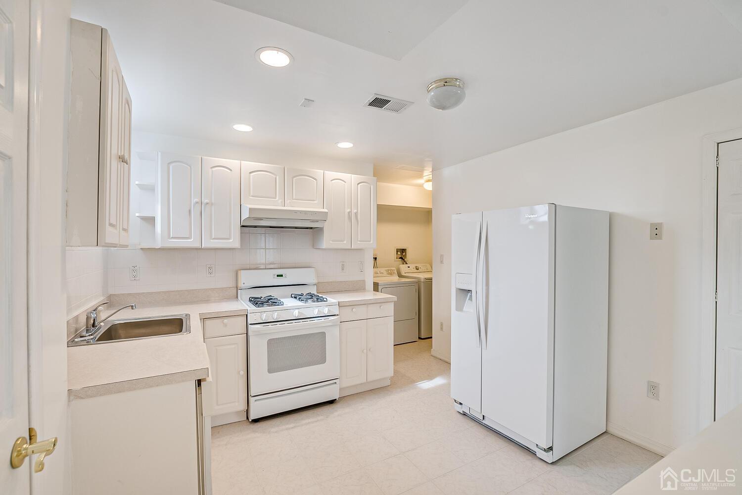 22 Timber Ridge Road North Brunswick, NJ 08902 - Photo 40 of 50 a kitchen with a stove sink and refrigerator