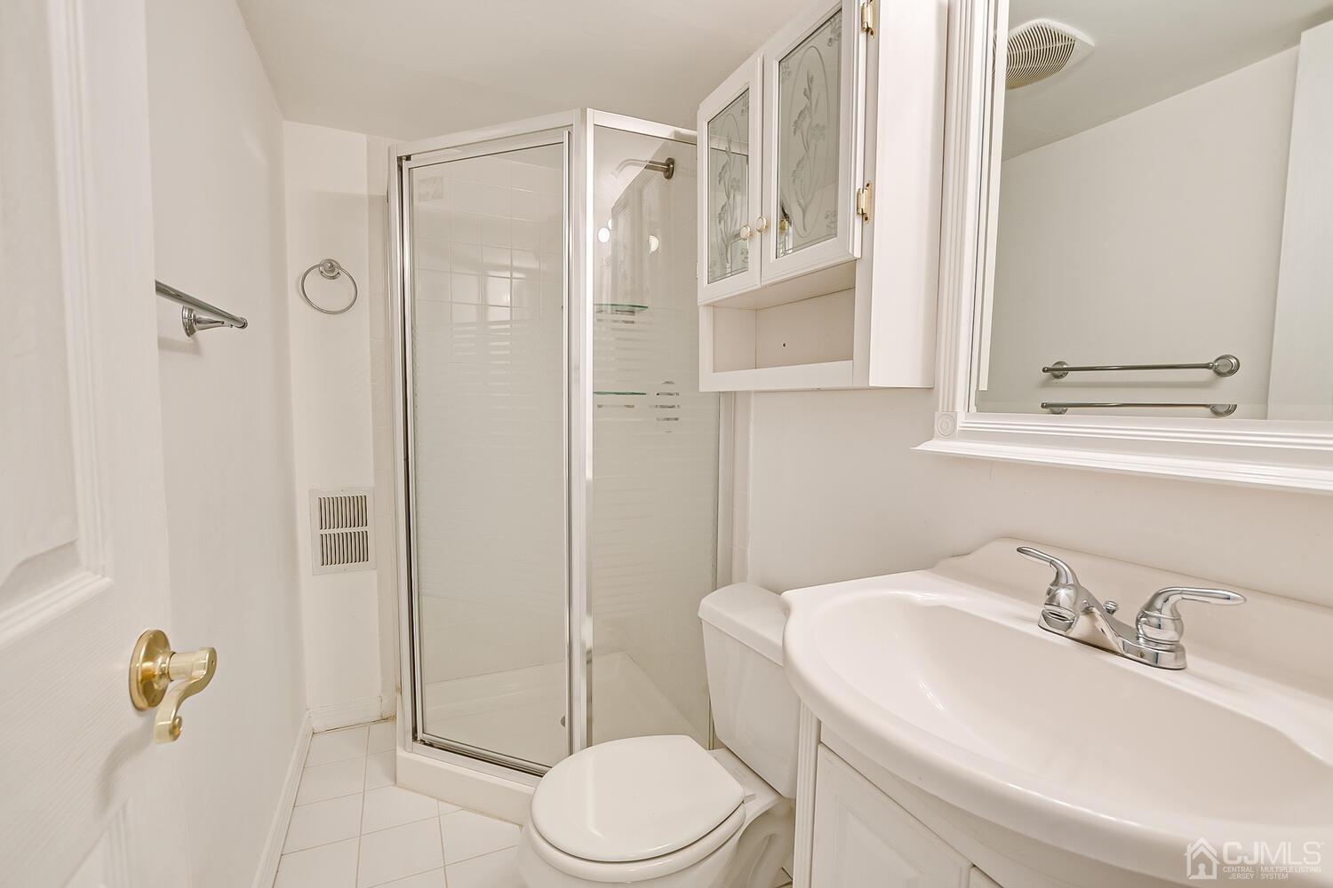 22 Timber Ridge Road North Brunswick, NJ 08902 - Photo 47 of 50 a bathroom with a sink vanity mirror and toilet