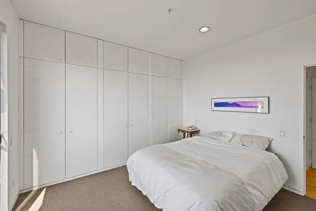 a bedroom with a bed and a chair