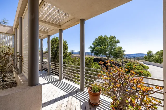 a living room with furniture stove and large window