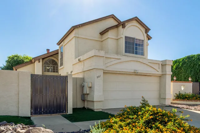 a view of a house with a small yard and plants
