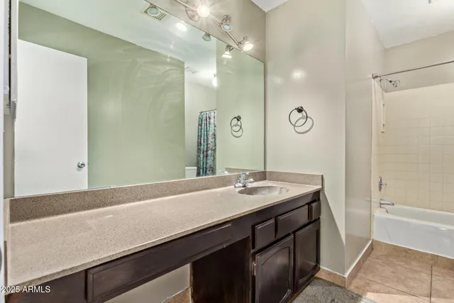 a bathroom with a sink a mirror and a shower