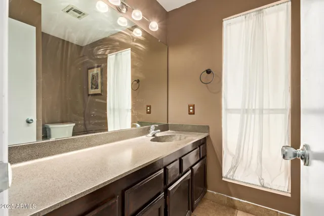 a bathroom with a sink a vanity and a mirror